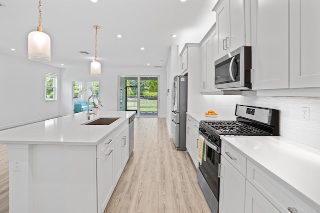 11695 SW Viridian Blvd, Port Saint Lucie, FL 34987 - kitchen with stainless steel appliances, healthy amount of natural light, light wood finished floors, light countertops, and recessed lighting