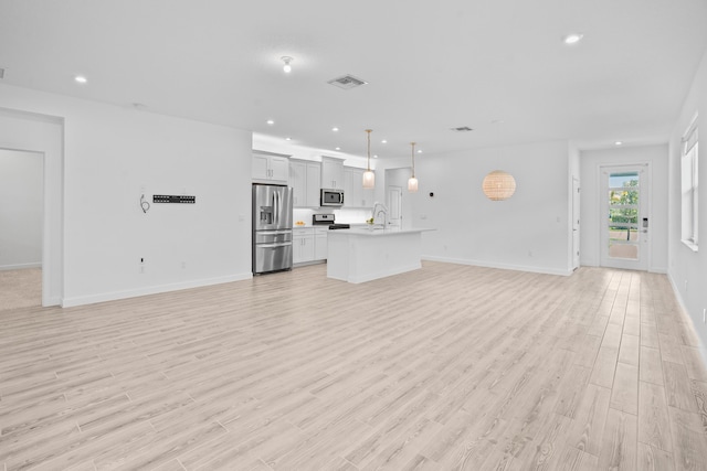 11695 SW Viridian Blvd, Port Saint Lucie, FL 34987 - unfurnished living room with light wood finished floors and recessed lighting