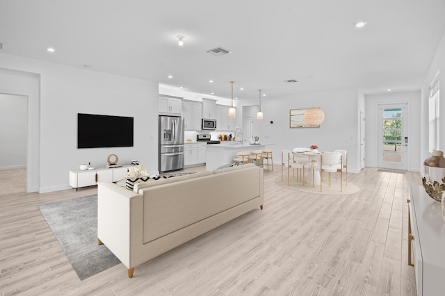 11695 SW Viridian Blvd, Port Saint Lucie, FL 34987 - living area featuring light wood-style floors and recessed lighting