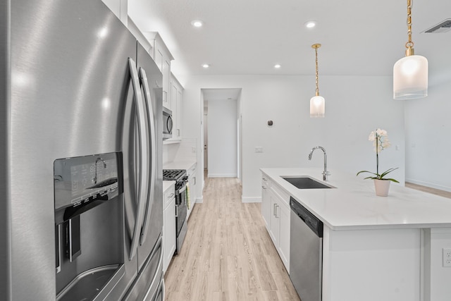 11695 SW Viridian Blvd, Port Saint Lucie, FL 34987 - kitchen featuring stainless steel appliances, light wood-style floors, white cabinets, an island with sink, and recessed lighting