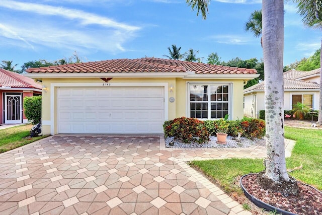 8140 Palm Gate Dr, Boynton Beach, FL 33436 - mediterranean / spanish home featuring driveway, stucco siding, a tiled roof, and an attached garage