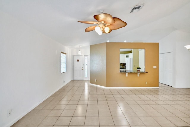 8140 Palm Gate Dr, Boynton Beach, FL 33436 - unfurnished living room featuring ceiling fan, light tile patterned flooring, and vaulted ceiling
