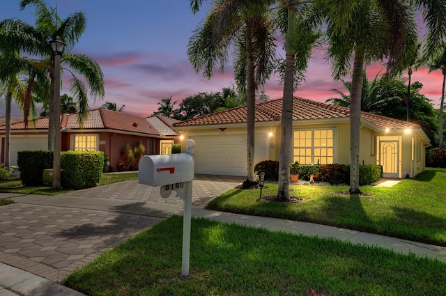 8140 Palm Gate Dr, Boynton Beach, FL 33436 - view of front of house featuring a tile roof, a garage, stucco siding, decorative driveway, and a lawn