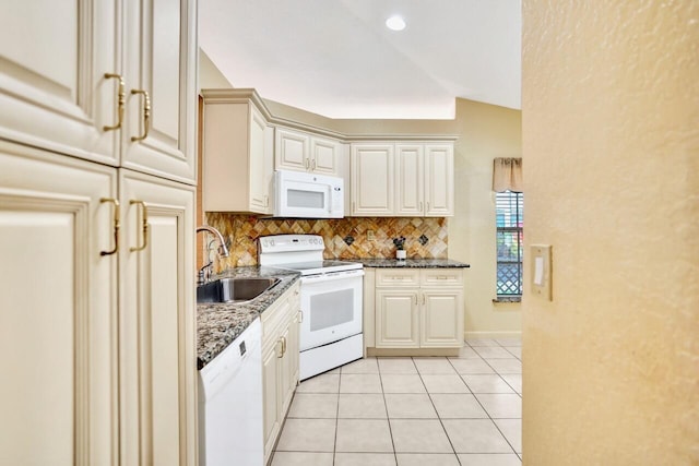 8140 Palm Gate Dr, Boynton Beach, FL 33436 - kitchen featuring white appliances, tasteful backsplash, light tile patterned flooring, and dark stone countertops