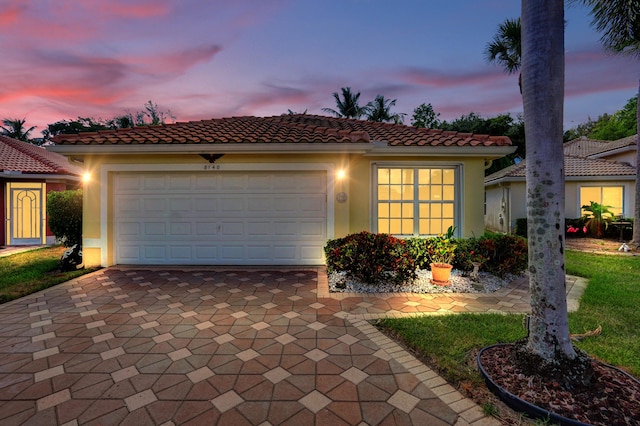 8140 Palm Gate Dr, Boynton Beach, FL 33436 - mediterranean / spanish-style house with decorative driveway, stucco siding, an attached garage, and a tile roof