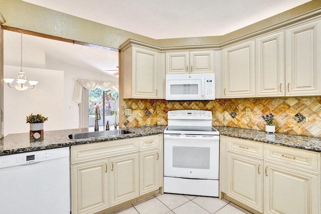8140 Palm Gate Dr, Boynton Beach, FL 33436 - kitchen with white appliances, lofted ceiling, tasteful backsplash, light tile patterned flooring, and a chandelier