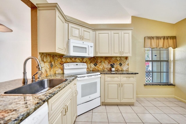 8140 Palm Gate Dr, Boynton Beach, FL 33436 - kitchen featuring white appliances, backsplash, light tile patterned floors, vaulted ceiling, and stone counters