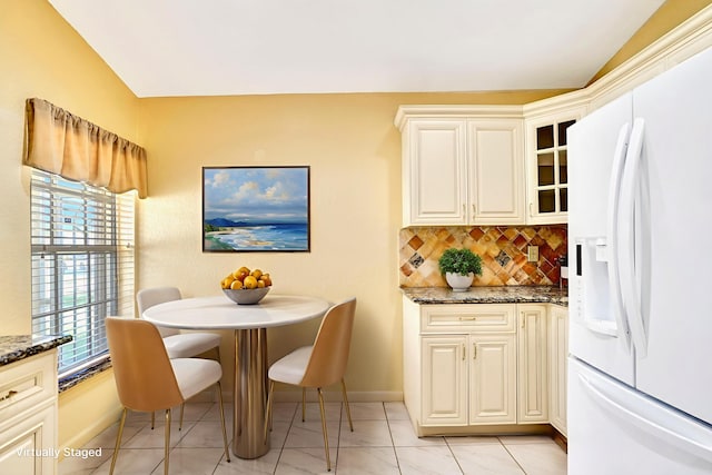 8140 Palm Gate Dr, Boynton Beach, FL 33436 - dining room with light tile patterned floors and vaulted ceiling