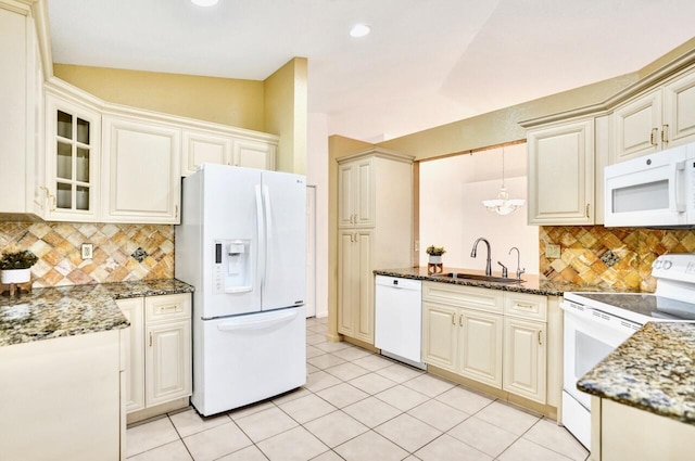 8140 Palm Gate Dr, Boynton Beach, FL 33436 - kitchen with white appliances, dark stone countertops, backsplash, glass insert cabinets, and recessed lighting