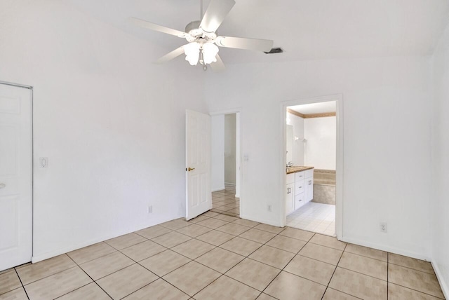 8140 Palm Gate Dr, Boynton Beach, FL 33436 - unfurnished bedroom featuring light tile patterned floors, vaulted ceiling, a ceiling fan, and ensuite bath