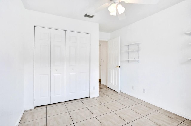 8140 Palm Gate Dr, Boynton Beach, FL 33436 - unfurnished bedroom with a closet, light tile patterned floors, and a ceiling fan