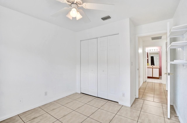 8140 Palm Gate Dr, Boynton Beach, FL 33436 - unfurnished bedroom featuring light tile patterned flooring, a closet, and a ceiling fan
