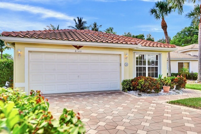 8140 Palm Gate Dr, Boynton Beach, FL 33436 - mediterranean / spanish house featuring driveway, a garage, stucco siding, and a tile roof