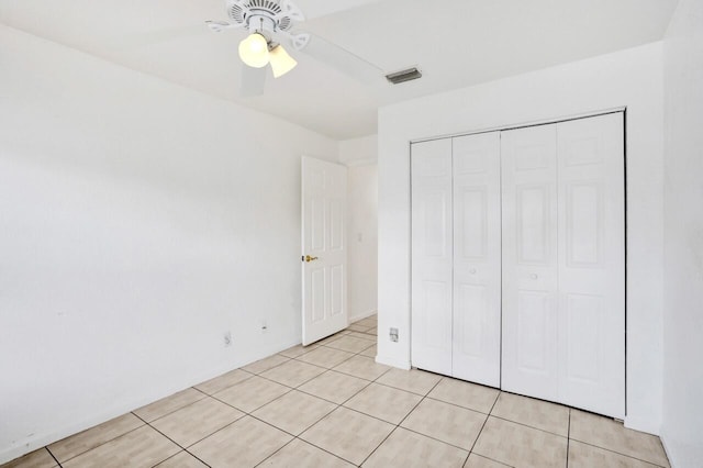 8140 Palm Gate Dr, Boynton Beach, FL 33436 - unfurnished bedroom featuring light tile patterned floors, a closet, and ceiling fan