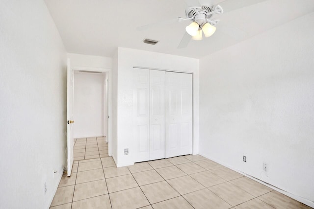 8140 Palm Gate Dr, Boynton Beach, FL 33436 - unfurnished bedroom with light tile patterned floors, a closet, and a ceiling fan