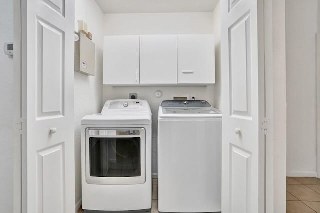 8140 Palm Gate Dr, Boynton Beach, FL 33436 - laundry area with washing machine and clothes dryer, cabinet space, and light tile patterned floors