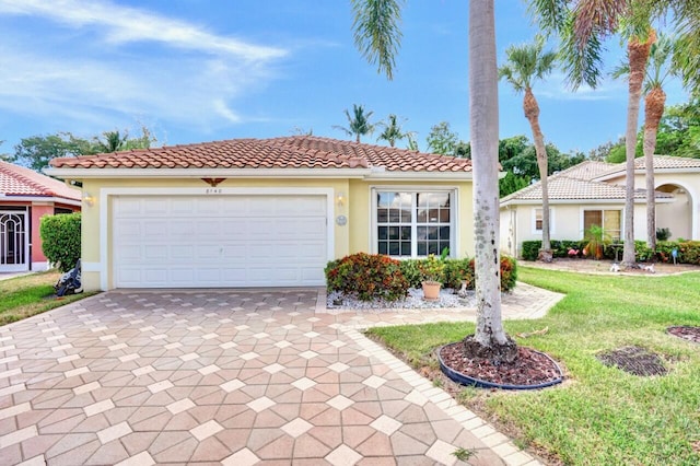 8140 Palm Gate Dr, Boynton Beach, FL 33436 - mediterranean / spanish house featuring decorative driveway, stucco siding, a garage, and a front lawn