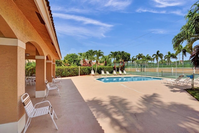8140 Palm Gate Dr, Boynton Beach, FL 33436 - community pool featuring a patio area and a tennis court