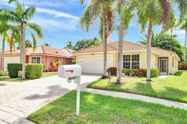 8140 Palm Gate Dr, Boynton Beach, FL 33436 - view of front of home featuring driveway, stucco siding, a tiled roof, an attached garage, and a front yard
