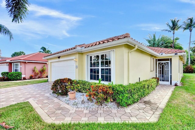 8140 Palm Gate Dr, Boynton Beach, FL 33436 - view of home's exterior featuring stucco siding, an attached garage, a tile roof, and driveway