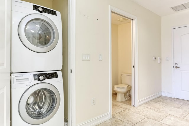 701 S Olive Ave Unit 1208, West Palm Beach, FL 33401 - laundry room featuring estacked washer and dryer and baseboards