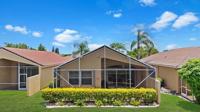 7052 Cataluna Cir, Delray Beach, FL 33446 - rear view of house featuring stucco siding, a tiled roof, a yard, and a lanai