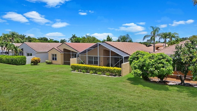 7052 Cataluna Cir, Delray Beach, FL 33446 - rear view of property featuring a tile roof, a yard, glass enclosure, and stucco siding