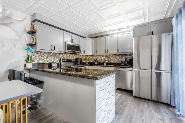 22164 Boca Rancho Dr Unit D, Boca Raton, FL 33428 - kitchen featuring appliances with stainless steel finishes, an ornate ceiling, a peninsula, decorative backsplash, and open shelves