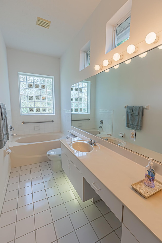 619 NW Monticello Pl, Port Saint Lucie, FL 34986 - bathroom featuring a garden tub, tile patterned flooring, and double vanity