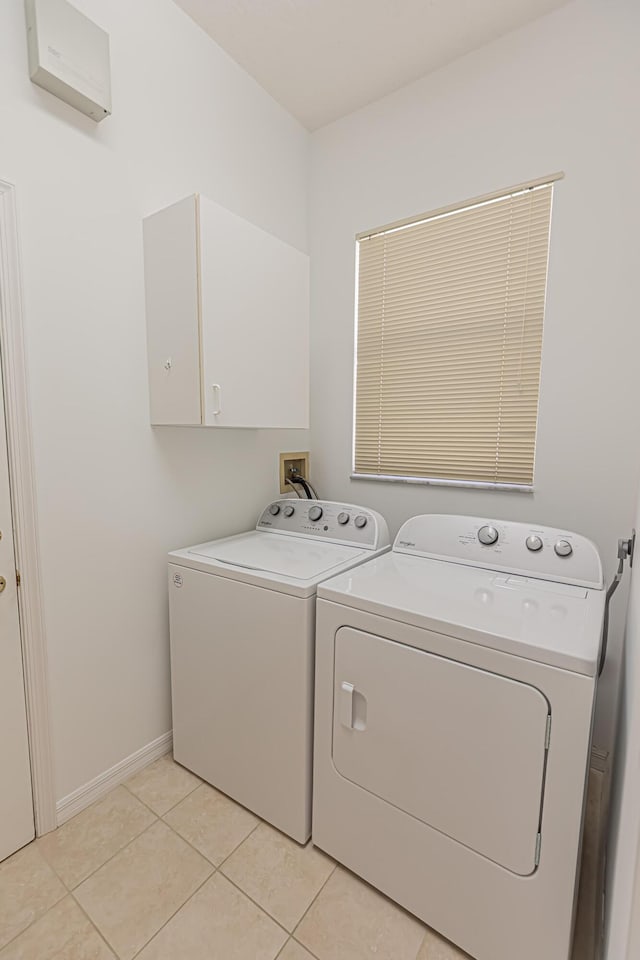619 NW Monticello Pl, Port Saint Lucie, FL 34986 - laundry room with separate washer and dryer, cabinet space, and light tile patterned floors