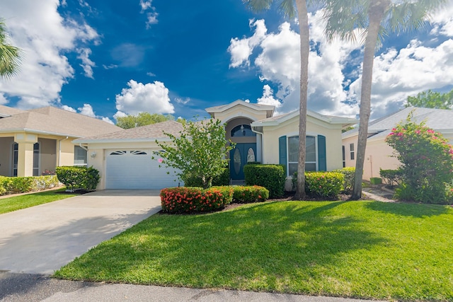 619 NW Monticello Pl, Port Saint Lucie, FL 34986 - view of front of property featuring stucco siding, an attached garage, driveway, and a front lawn