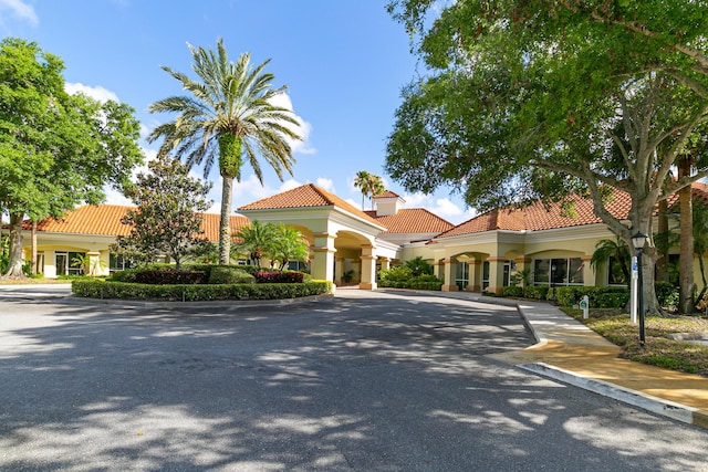 619 NW Monticello Pl, Port Saint Lucie, FL 34986 - mediterranean / spanish-style home with a tile roof and stucco siding