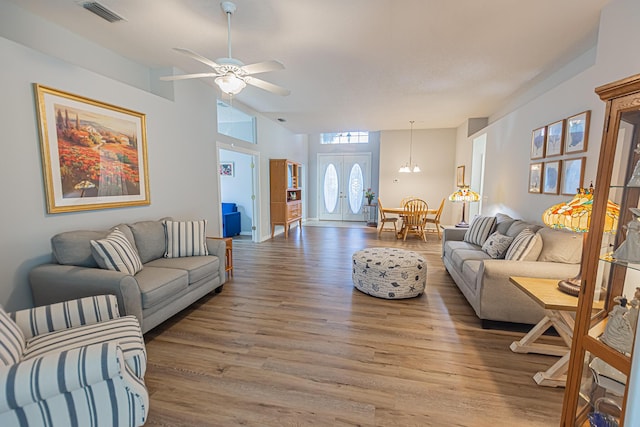 619 NW Monticello Pl, Port Saint Lucie, FL 34986 - living room with light wood finished floors, a ceiling fan, and lofted ceiling
