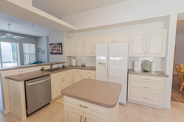 619 NW Monticello Pl, Port Saint Lucie, FL 34986 - kitchen featuring dishwasher, white fridge with ice dispenser, a peninsula, and light tile patterned floors