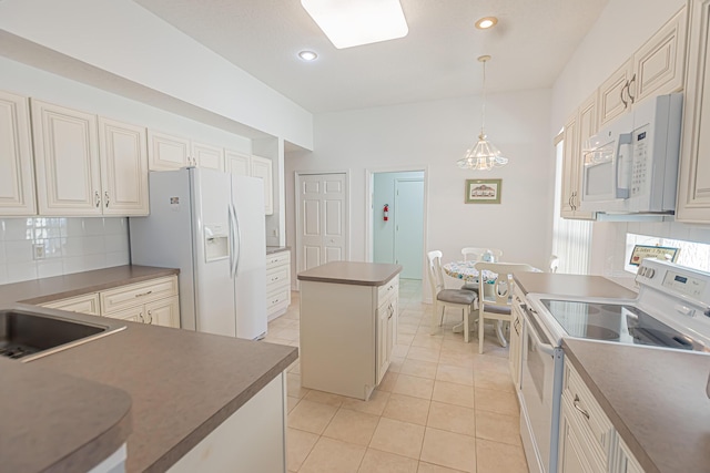 619 NW Monticello Pl, Port Saint Lucie, FL 34986 - kitchen with white appliances, a center island, backsplash, dark countertops, and recessed lighting