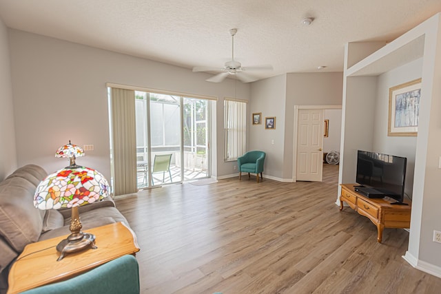 619 NW Monticello Pl, Port Saint Lucie, FL 34986 - living room with light wood-style flooring, ceiling fan, and a textured ceiling