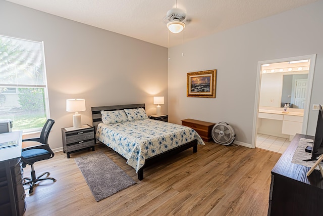 619 NW Monticello Pl, Port Saint Lucie, FL 34986 - bedroom featuring light wood-style floors, a desk, and connected bathroom