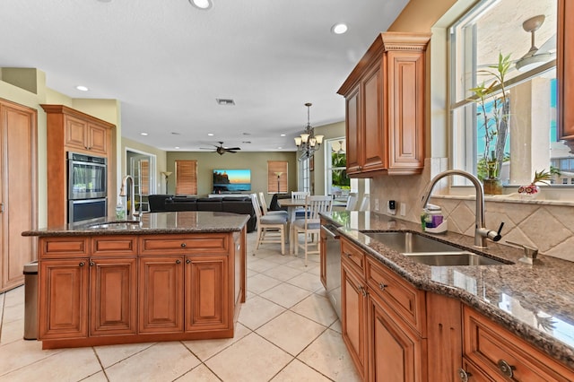 7486 Greenville Cir, Lake Worth, FL 33467 - kitchen with recessed lighting, a chandelier, open floor plan, ceiling fan, and dark stone counters