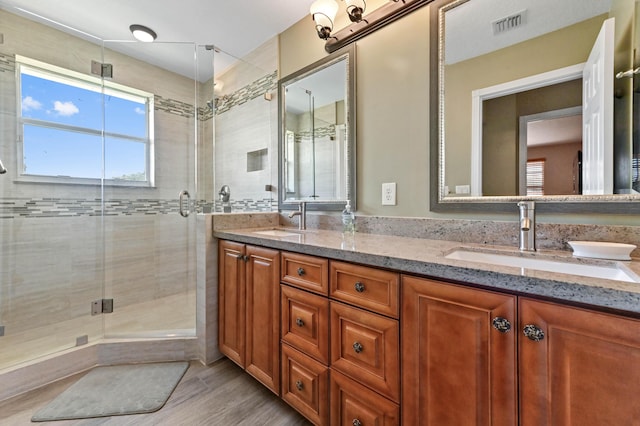 7486 Greenville Cir, Lake Worth, FL 33467 - bathroom featuring double vanity, a stall shower, and wood finished floors