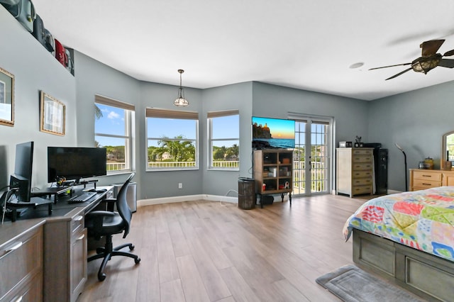 7486 Greenville Cir, Lake Worth, FL 33467 - bedroom featuring multiple windows, an office area, light wood-style floors, and a ceiling fan