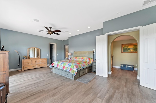 7486 Greenville Cir, Lake Worth, FL 33467 - bedroom featuring light wood-style flooring, arched walkways, recessed lighting, and ceiling fan