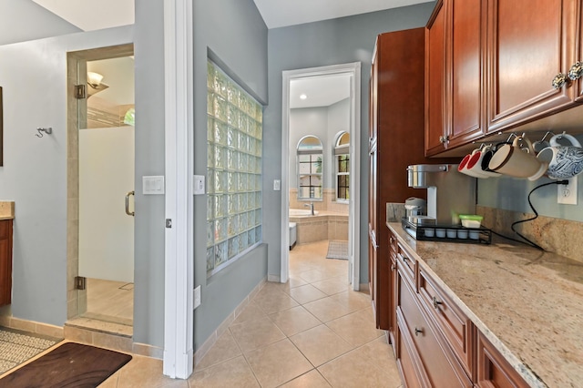 7486 Greenville Cir, Lake Worth, FL 33467 - kitchen featuring light tile patterned floors and light stone countertops