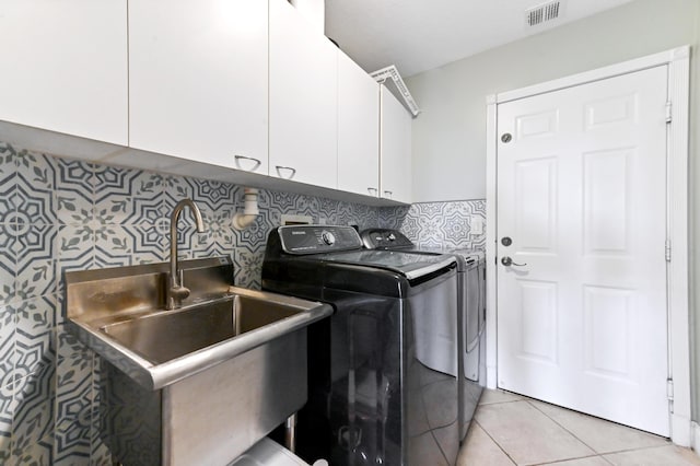 7486 Greenville Cir, Lake Worth, FL 33467 - laundry room featuring washer and dryer, cabinet space, and light tile patterned floors