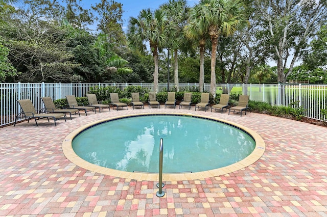 7486 Greenville Cir, Lake Worth, FL 33467 - community pool with a patio area and view of wooded area