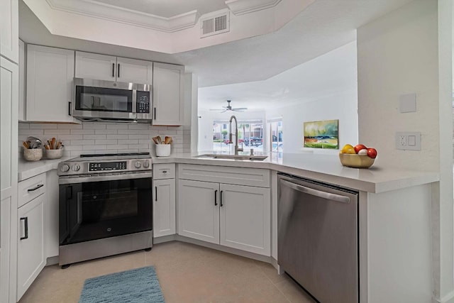 815 W Boynton Beach Blvd Unit 12-106, Boynton Beach, FL 33426 - kitchen featuring stainless steel appliances, light countertops, tasteful backsplash, and crown molding