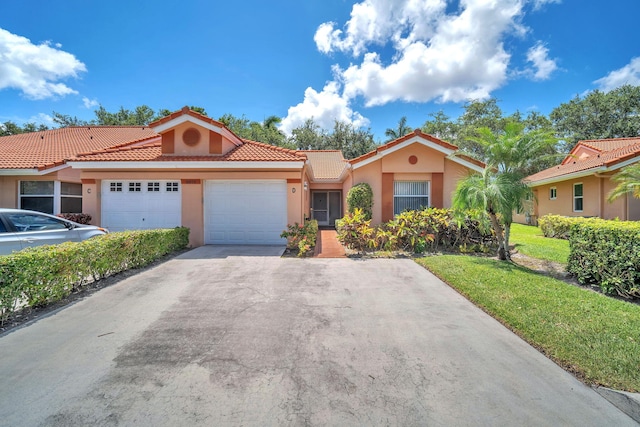 9976 Seacrest Cir Unit D, Boynton Beach, FL 33437 - mediterranean / spanish house featuring a garage, stucco siding, a tile roof, and asphalt driveway