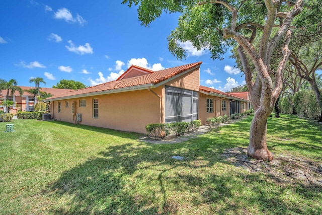 9976 Seacrest Cir Unit D, Boynton Beach, FL 33437 - back of property featuring stucco siding, a tile roof, and a lawn