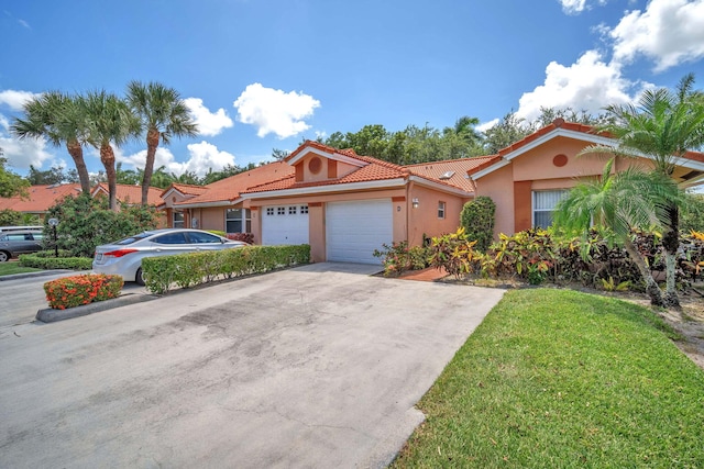 9976 Seacrest Cir Unit D, Boynton Beach, FL 33437 - mediterranean / spanish-style house with stucco siding, a tile roof, a garage, a front lawn, and driveway