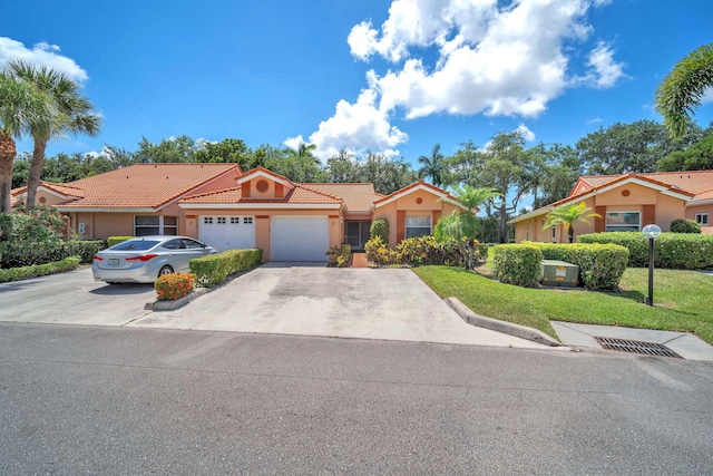 9976 Seacrest Cir Unit D, Boynton Beach, FL 33437 - view of front of property featuring a tiled roof, an attached garage, stucco siding, concrete driveway, and a front yard
