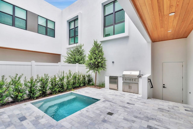 1921 Dock St, West Palm Beach, FL 33401 - view of swimming pool with exterior kitchen and a patio